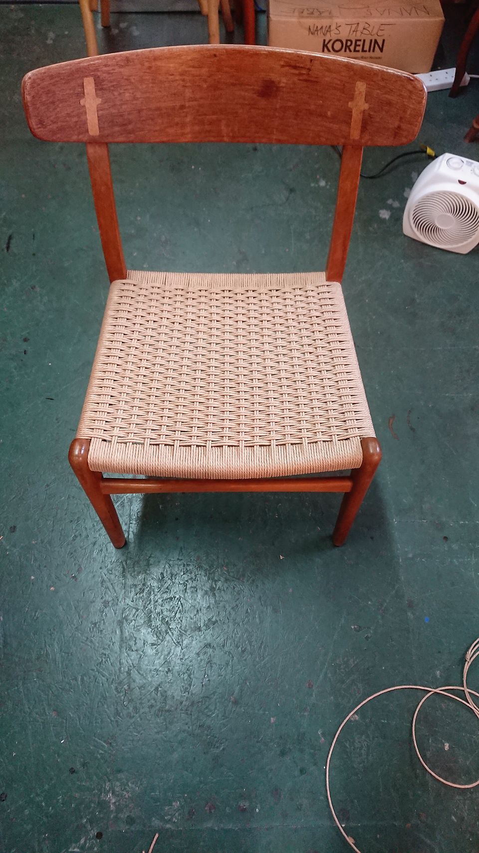 Dining chair with a woven Danish cord seat and contrasting keys in the back rail