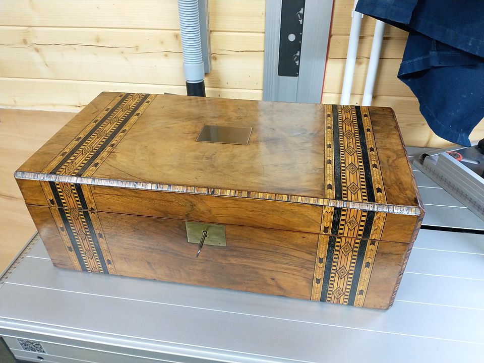 Writing box with parquetry banding, a brass plaque and brass escutcheon